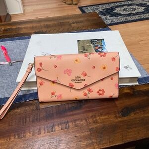 coach Adorable peach colored wallet great for travel can first most phones